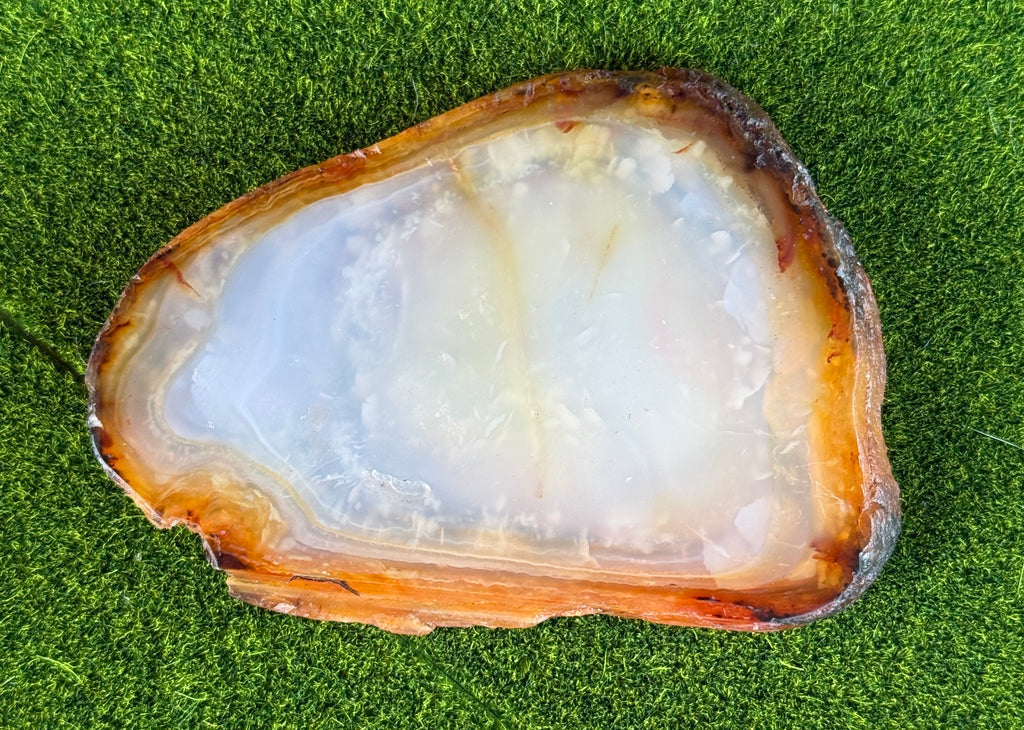 Geode slice on a green grass background