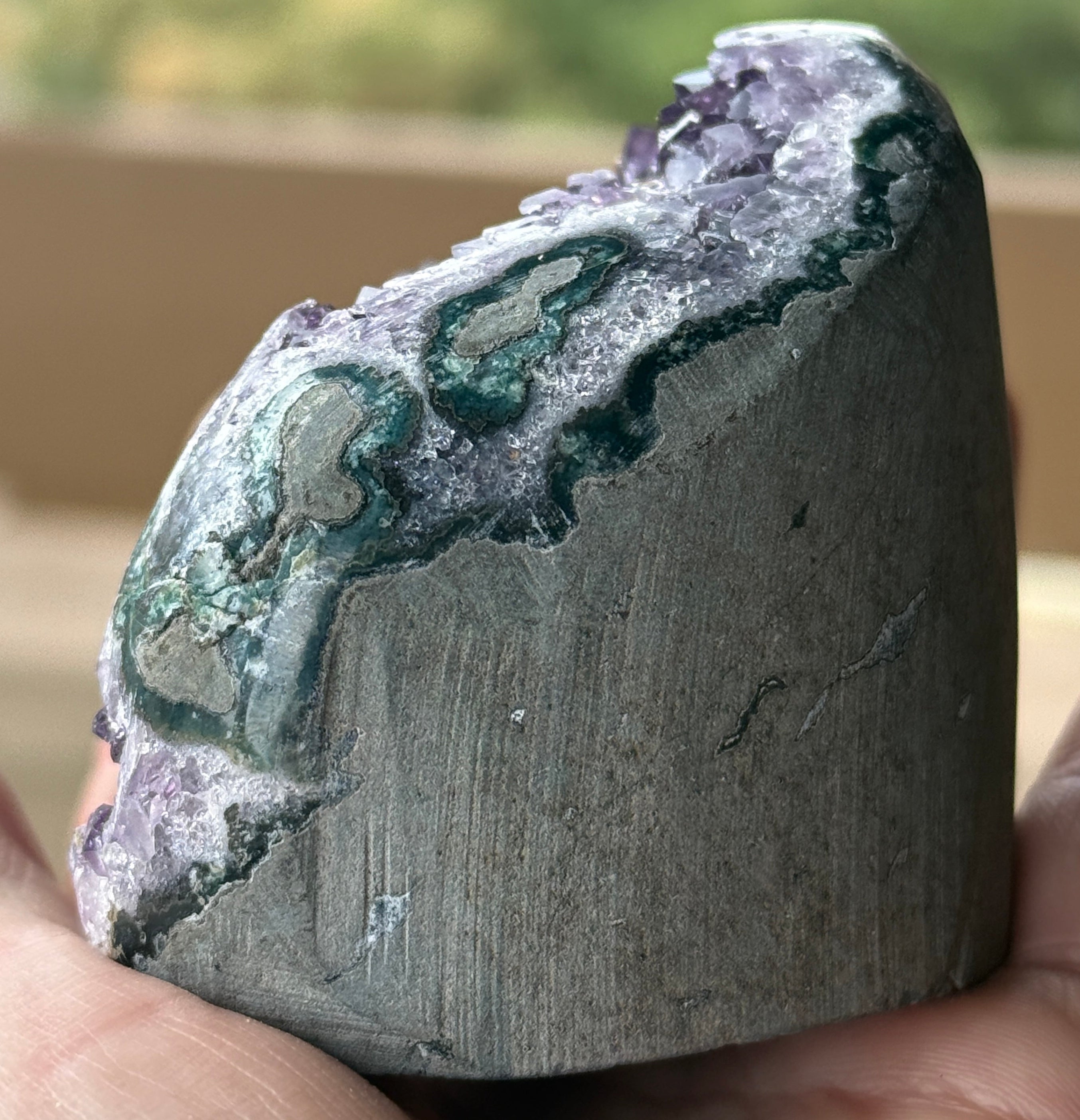 Polished amethyst stalactite slice with visible stalactite core and purple druzy crystals. Natural geode specimen for collectors and décor.